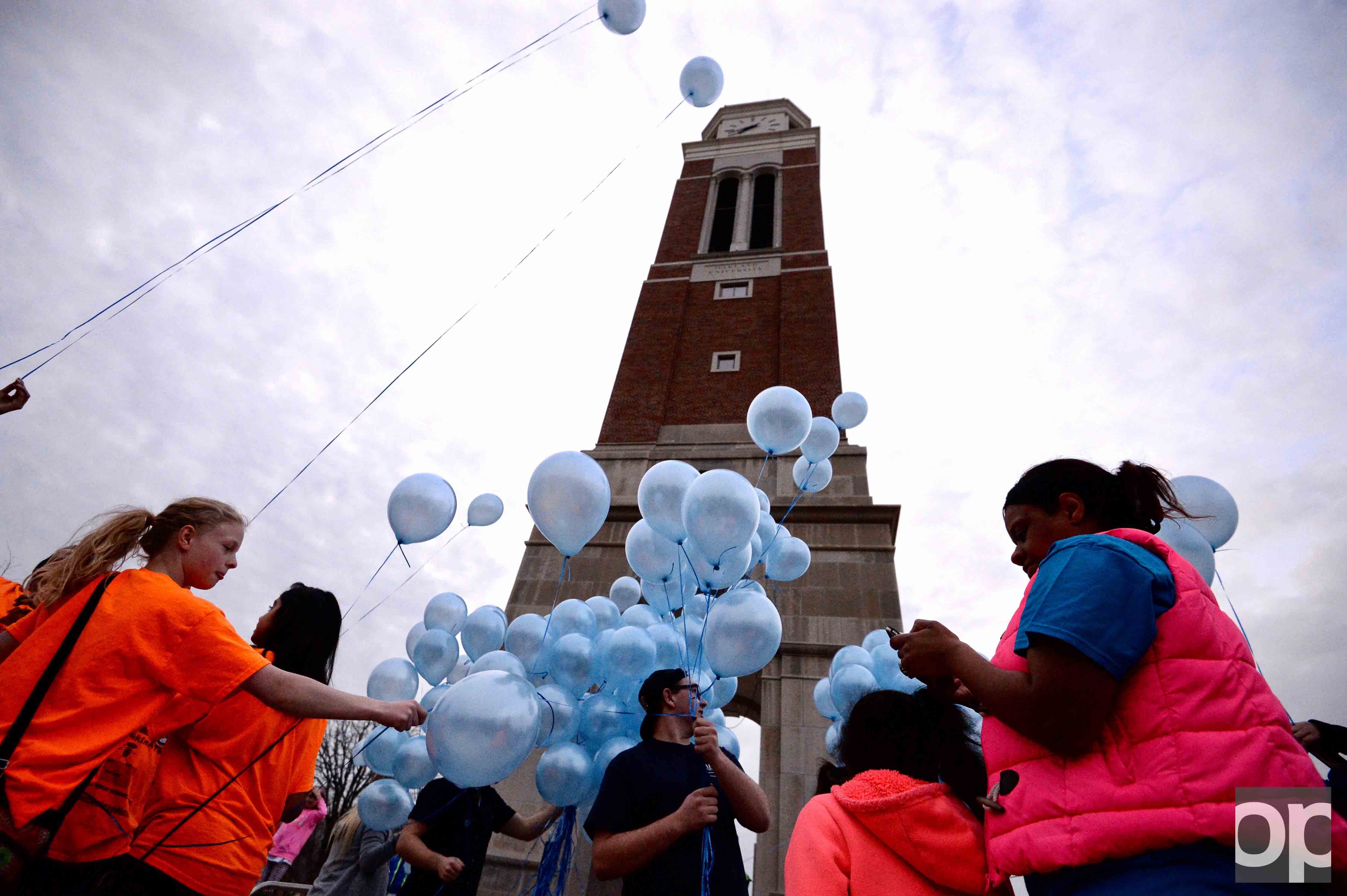 Participants gathered around the Elliott Tower with blue balloons on World Autism Awareness day.