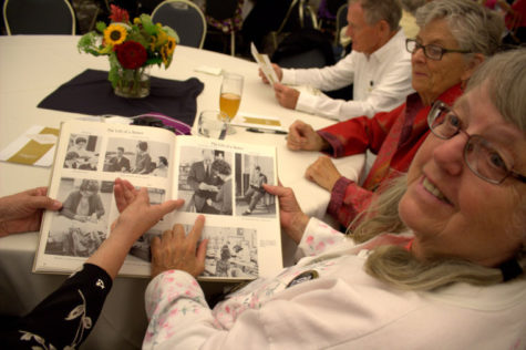 Patti Koenig, Charter Class Graduate of 1963, points to a photo of herself in the yearbook. 