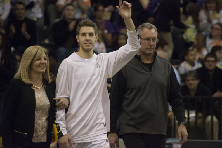 OU senior guard Travis Bader waves to fans as hes introduced on Senior Day.