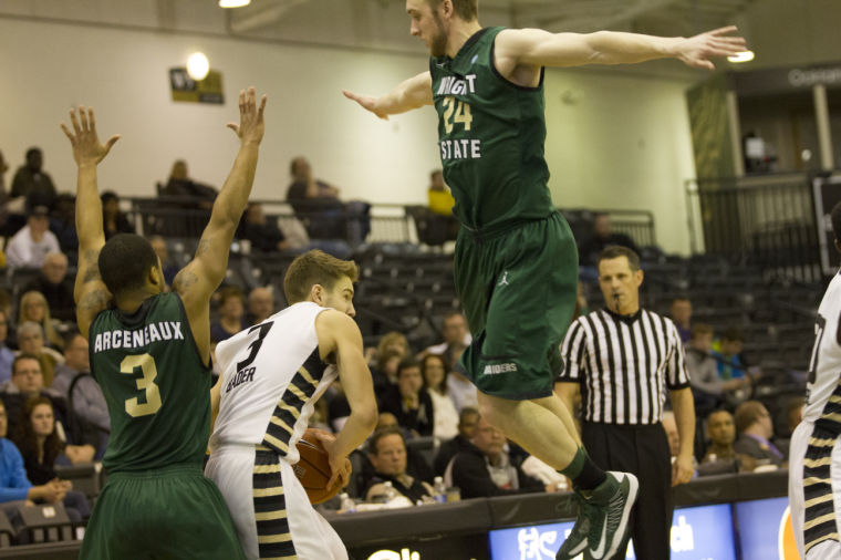 OU senior guard Travis Bader struggles to find space in a previous meeting with Wright State. Fridays contest fared better for Bader, who scored 20 points, but it wasnt enough - other than Bader, only junior forward Dante Williams scored in double figures for Oakland.