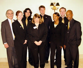 Blizman poses with one of his Students in Free Enterprise teams. Alex Cherup is the second to the right in the back row, and Brennon Edwards is the farthest on the right.