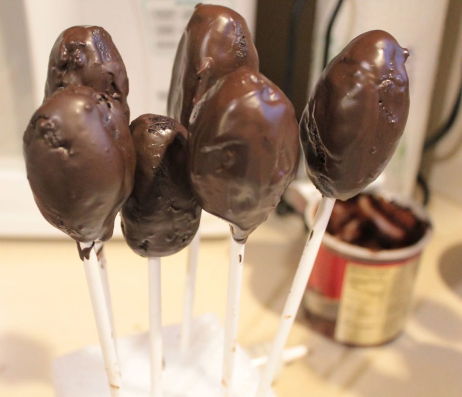 Dip the footballs in chocolate and stick them into the styrofoam cubes to dry.