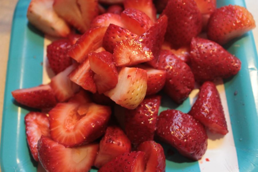Cut the strawberries in half, and then in half again.