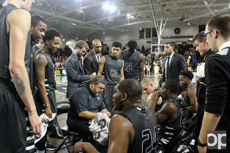 Oakland mens basketball team listens to coach Greg Kampe during a timeout at the first home game against EMU. The Golden Grizzlies defeated Green Bay Phoenix 111-95 on Saturday, Jan. 23 at the Resch Center in Green Bay, Wisconsin.