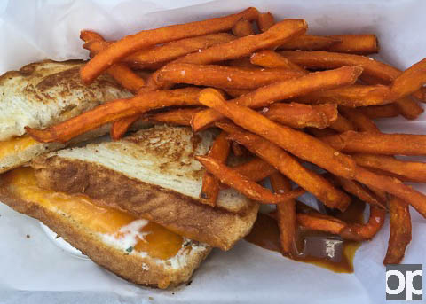 Smokey Paws sells Grilled Cheese Sandwich with the option to upgrade to Sweet Potato Fries and adding Pulled Pork 