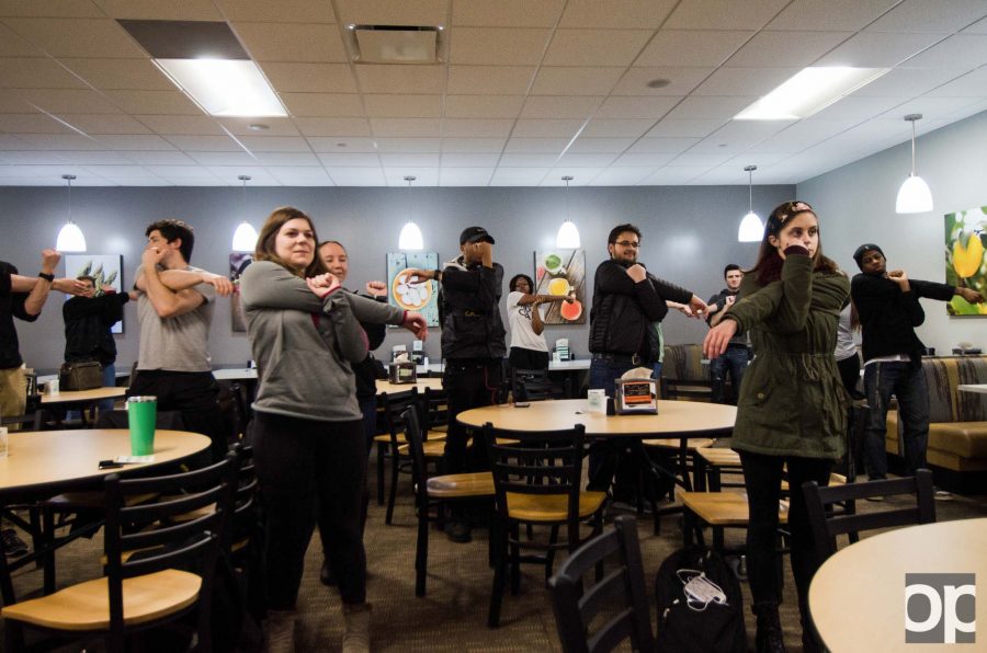 Participants practice different stretches and learn how to do quick activity movements while cramming for finals week at Sit Smart, Study Smart on Thursday, April 6.