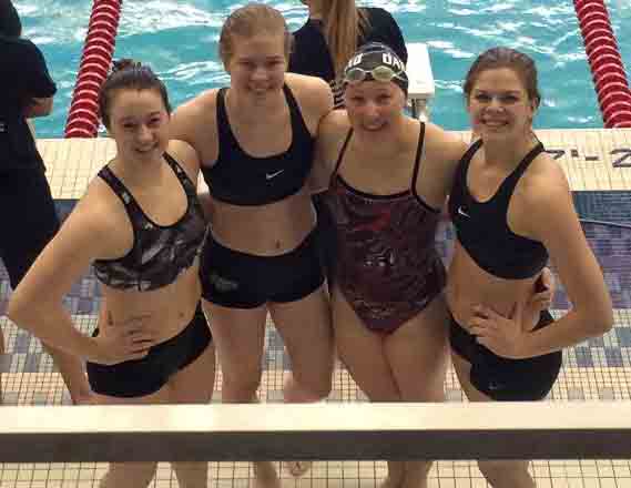 Three participants team up with a member from the Oakland swim team to take part in Water to Water fundraiser. 