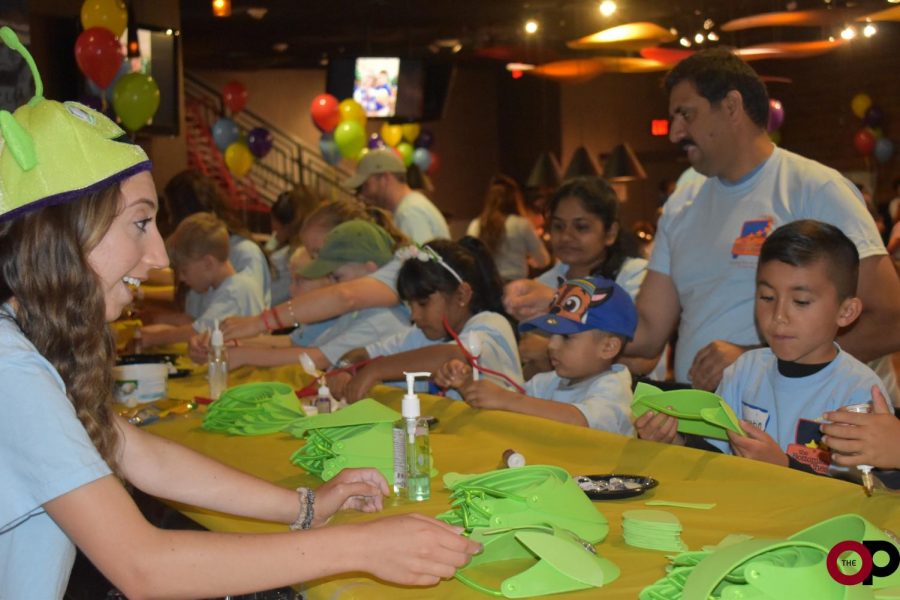 OU senior Rachel Pepe helps pediatric cancer patients with “Toy Story” crafts at the Bottomless Toy Chest Red Carpet Movie event.
