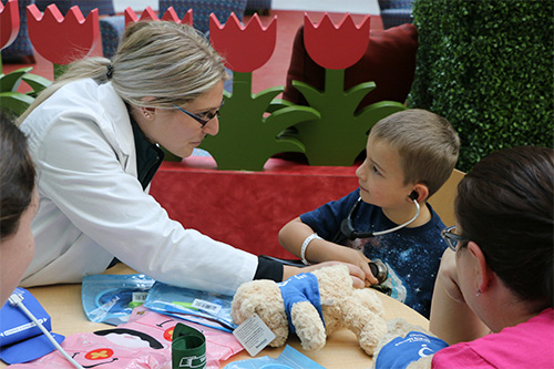 OUWB students lead kids in playing doctor on teddy bears at the annual Teddy Bear Clinic at Beaumont Children’s Hospital in Royal Oak on Friday, Nov. 1.
