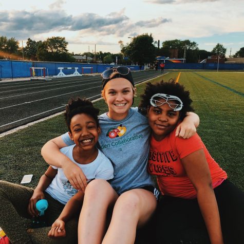 Aldred (middle) and some of her players embracing on the field. She is a new addition to the OU Club Lacrosse team, and works to provide access to sports for kids in Detroit. Photo / Summer Aldred
