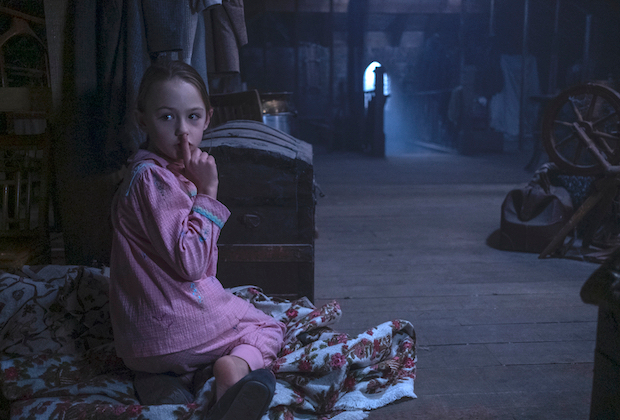 Flora hides in the attic at Bly Manor with a ghostly presence. Amelie Bae Smith plays Flora in Netflix’s “The Haunting of Bly Manor.”