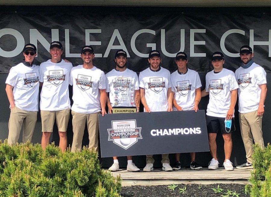 The OU Men's Golf team holding their new Horizon League Championship trophy.  After finishing in second place the past four years, the team finally earned their first Horizon League Championship in program history.