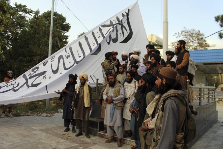Taliban fighters raise their flag at the Ghazni provincial governors house. They took control of the Afghan presidential palace two weeks before the U.S. finished withdrawing its troops. 