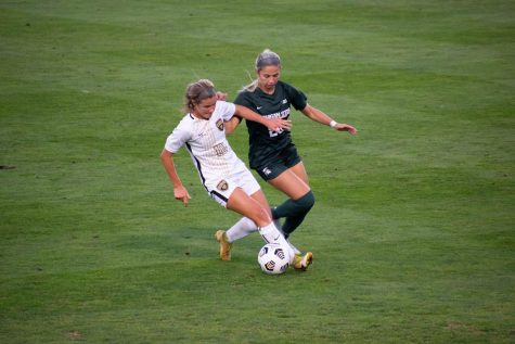 Midfielder Macey Wierenga trying to slip a defender against Michigan State on Thursday, Sept. 9, 2021. 