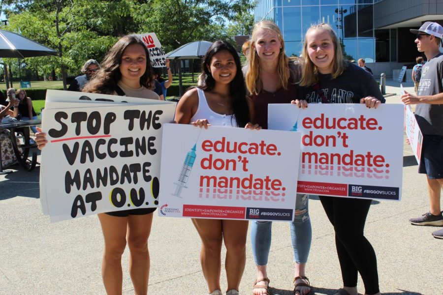 Members of the campus community holding up their anti-vaccine mandate signs at last Thursdays rally.