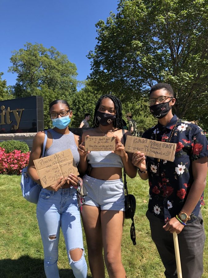 Jaliyah Langford, Litta Dillard and Raya Hollis holding signs at OU's entrance on September 1. Many students are joining faculty on the picket lines. 