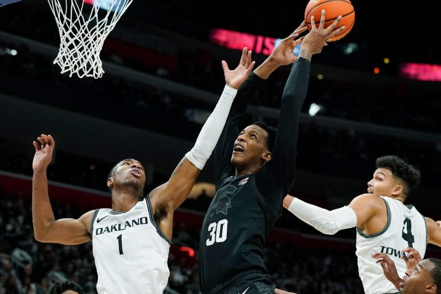 Michigan States Marcus Bingham Jr. goes for the rebound against Oakland on Dec. 21. Photo courtesy of the Lansing State Journal.