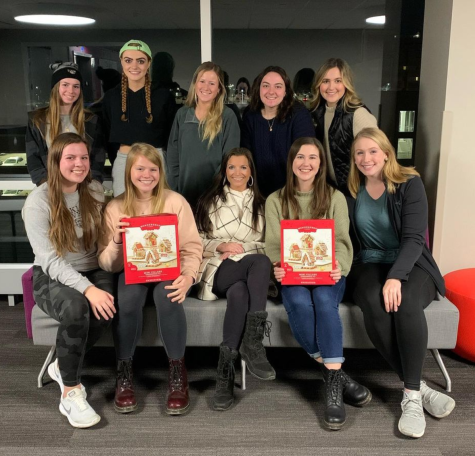 NeW members at the most recent event on Dec. 2. The group met for dinner, built gingerbread houses and filled out holiday cards for children in the hospital.