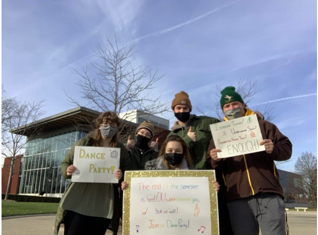 Recent OU alumna, Jenna Amore, and four other students gathered on Nov. 22 around Elliott Clock Tower to celebrate student accomplishments while protesting OU administration. 