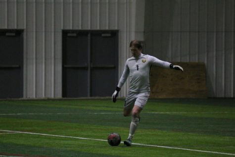 Finn Jurak kicks the ball out to his teammates against SVSU on March 26.