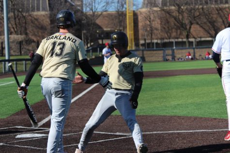 Seth Tucker scores on a sac fly to score the winning run for Oakland in game 1 of their series against UIC.