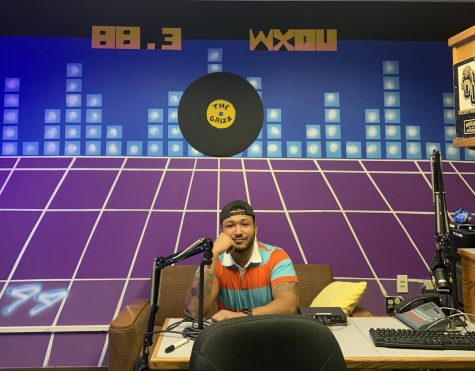 Justice Johnson and mural in 88.3 WXOU Live Station