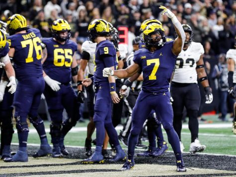 Michigan running back Donovan Edwards celebrates a touchdown scored tight end Luke Schoonmaker against Purdue during the first half of the Big Ten championship game on Saturday, Dec. 3, 2022, in Indianapolis.