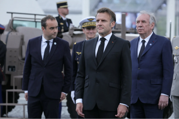 From left, Sébastien Lecornu, France's defense minister; the country's president, Emmanuel Macron; and Mr. Bayrou in May
